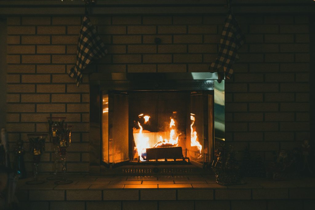 brown brick fireplace with brown brick wall