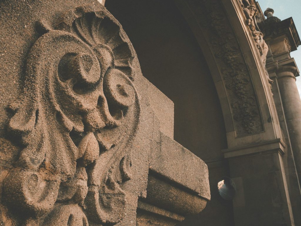 a close up of a stone carving on the side of a building