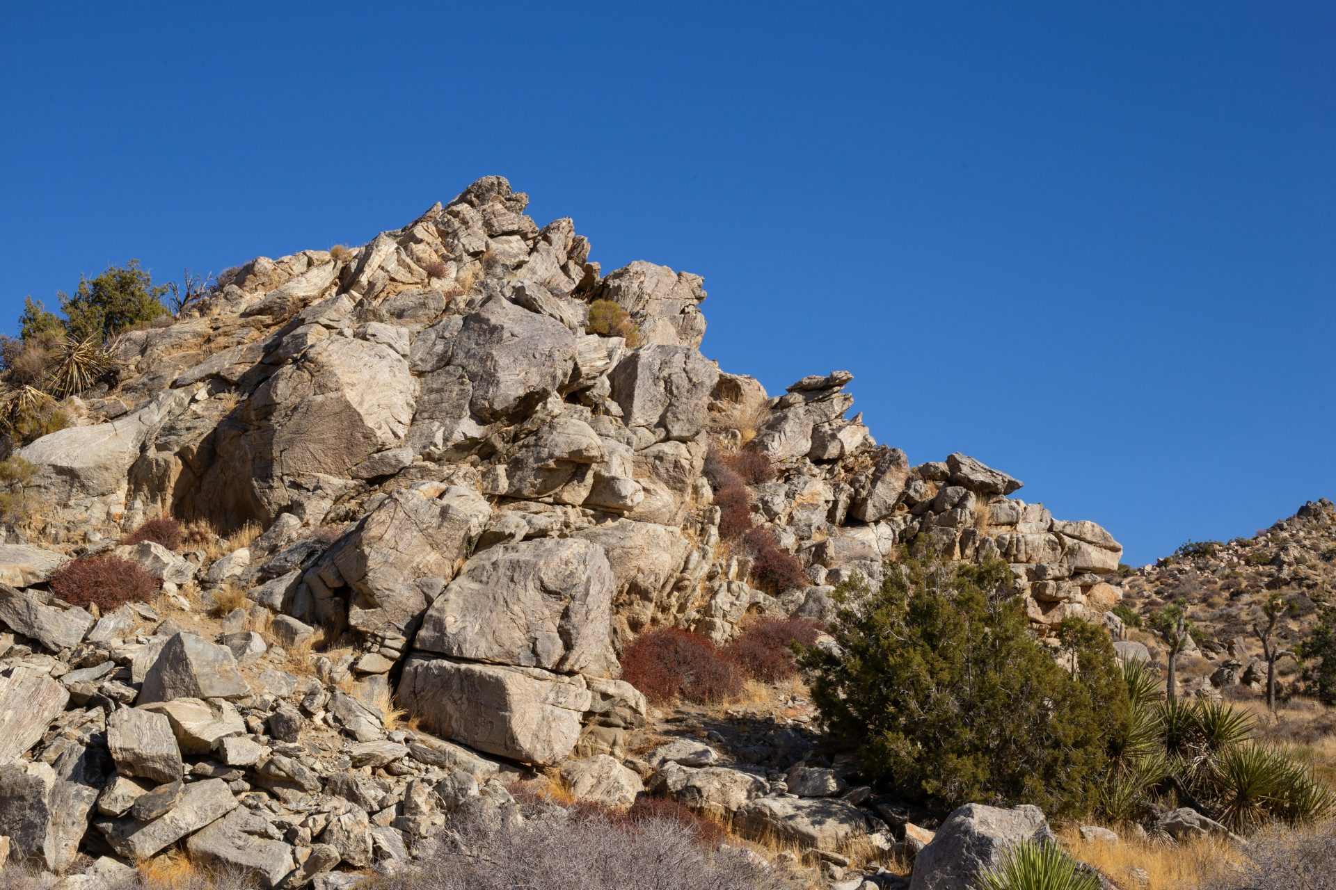 Rocky mountain landscape under a clear blue sky.