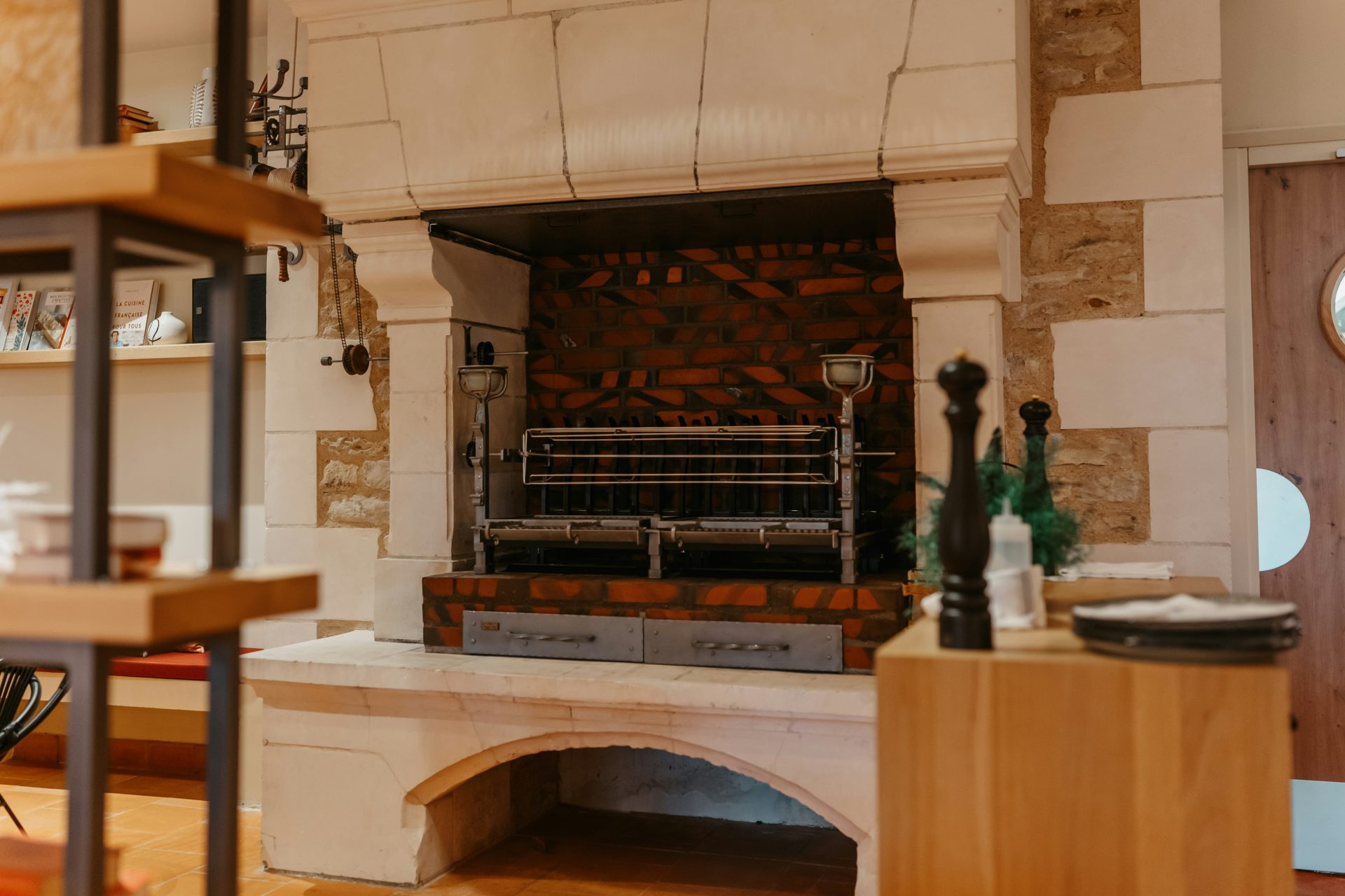 a kitchen with a brick oven and a clock on the wall