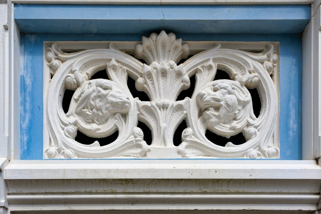 Ornate, white architectural detail set in blue.